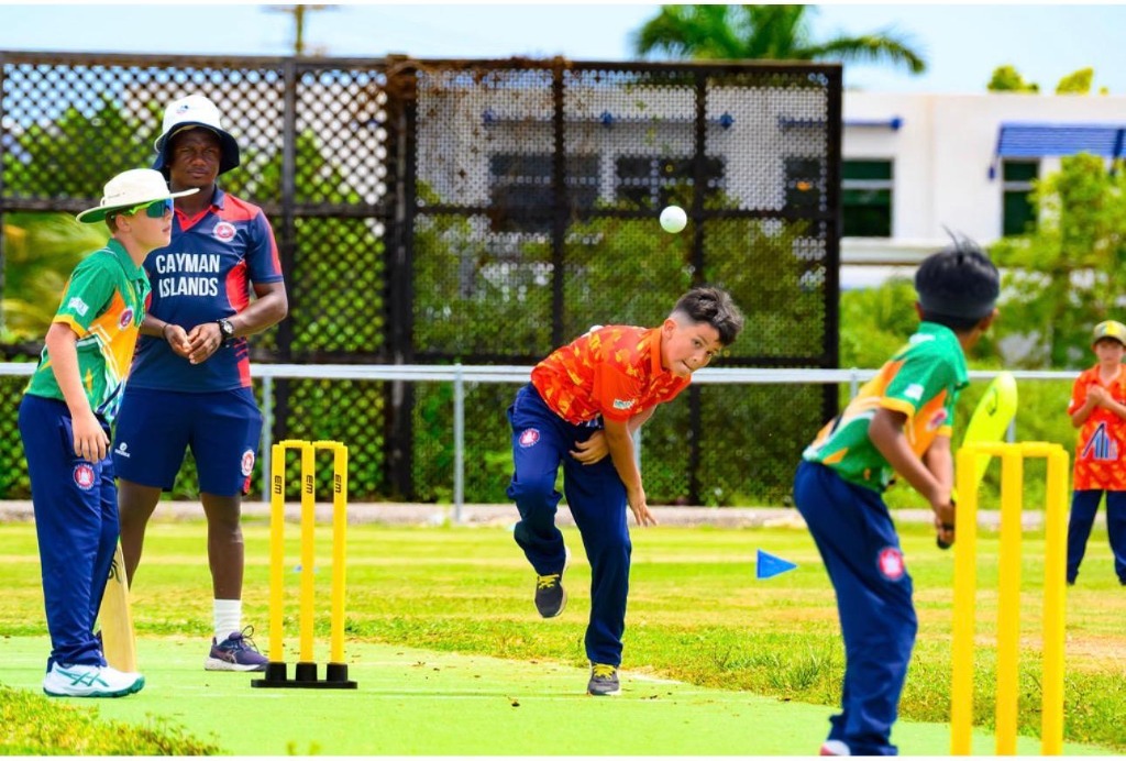 Cayman Junior Cricket Matchday Action with Coach