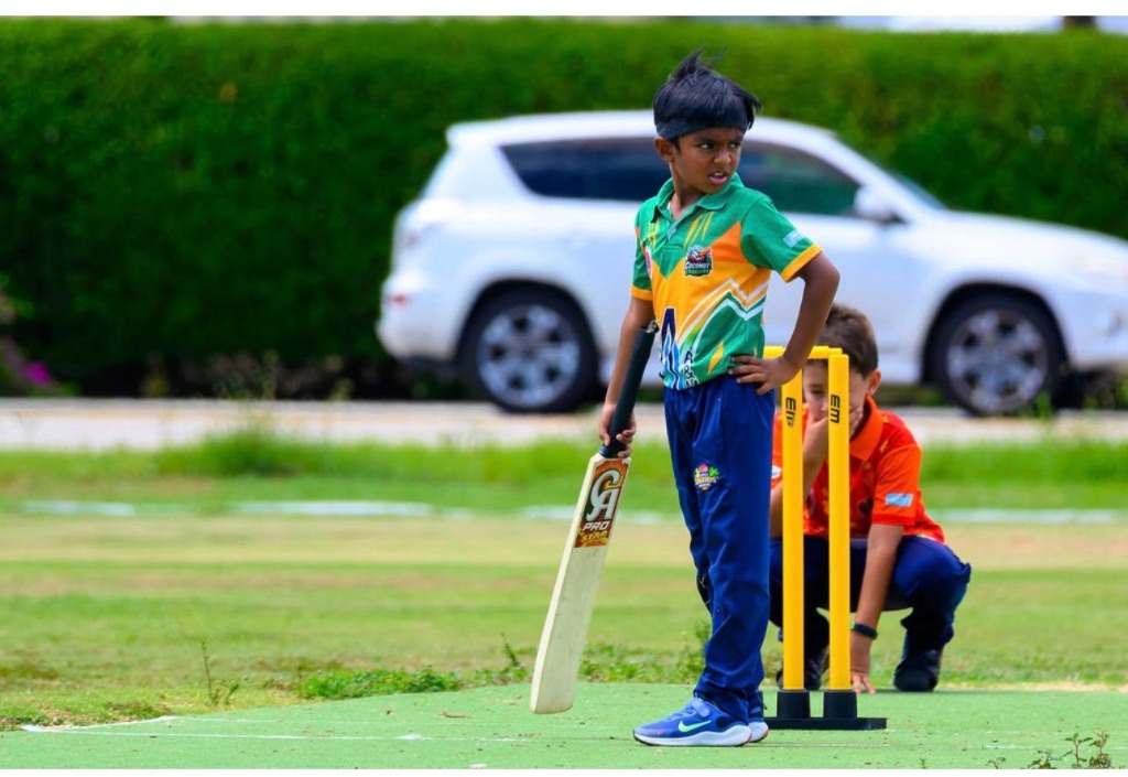 Junior batter at the crease with CA Pro Star bat and keeper behind